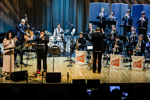A group of musicians perform live on stage at the University of Miami